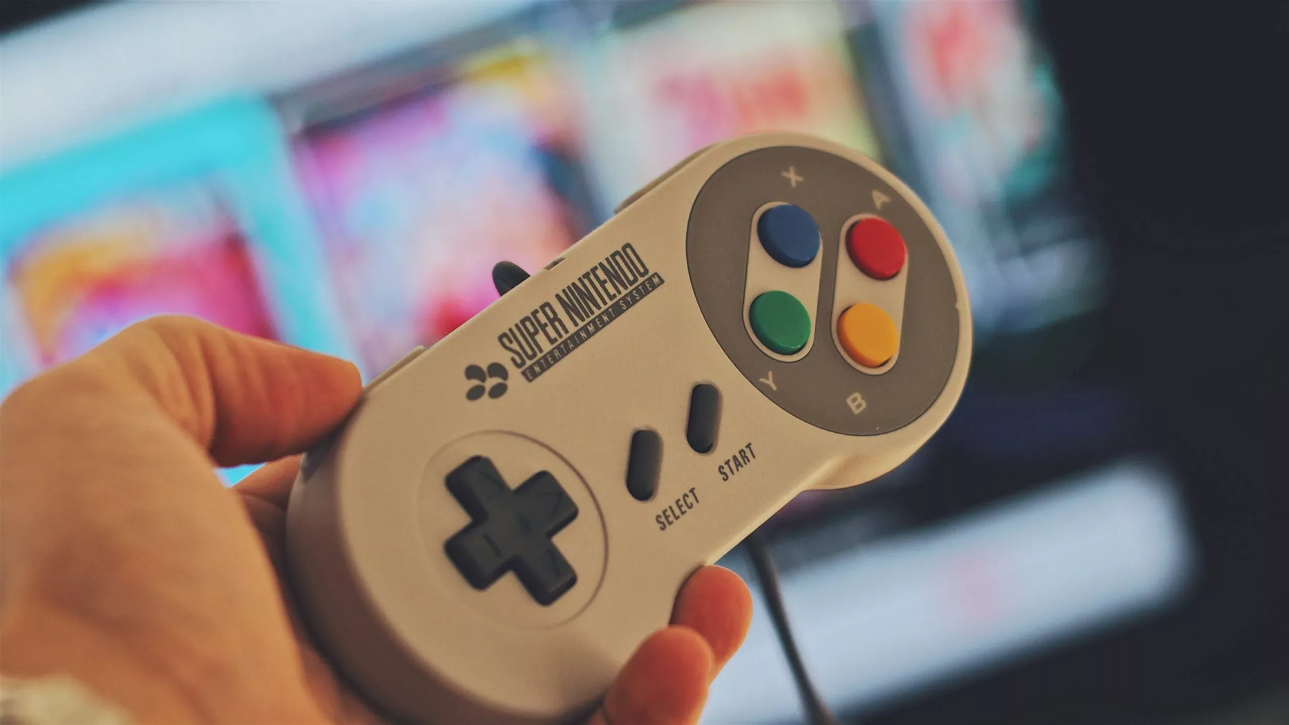 Hand holding a SNES controller